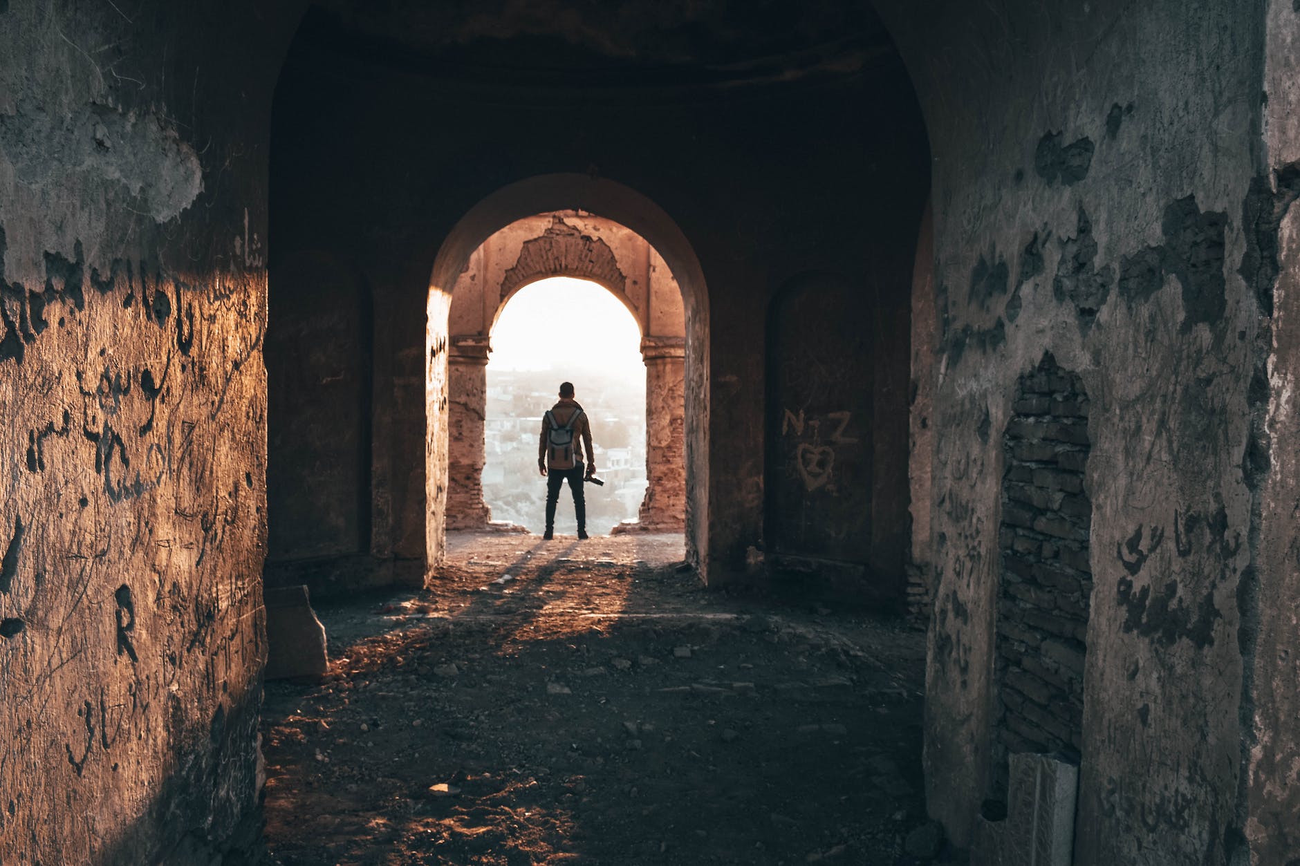 man framed standing on arch doorway