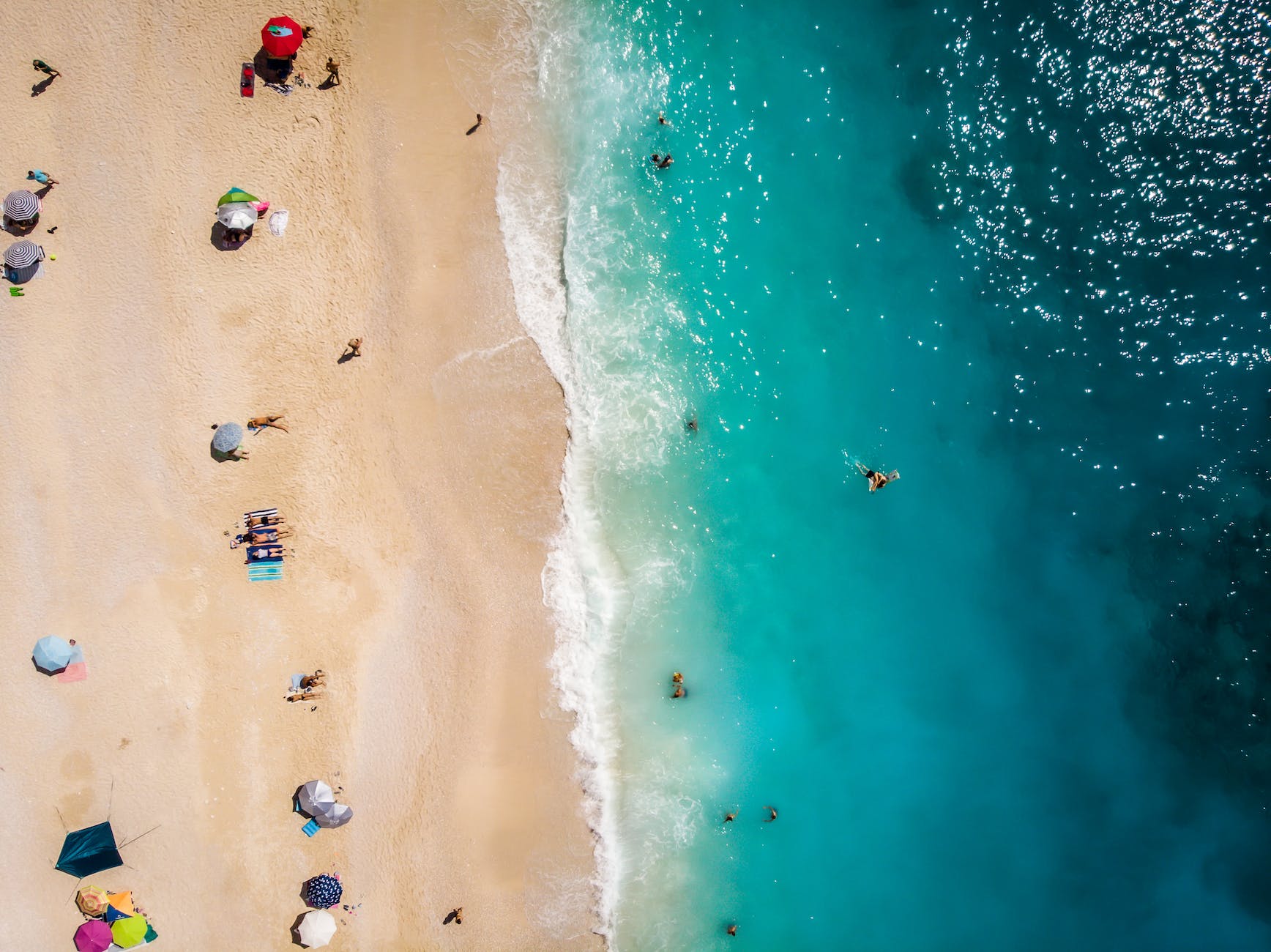 people having fun on the beach from above