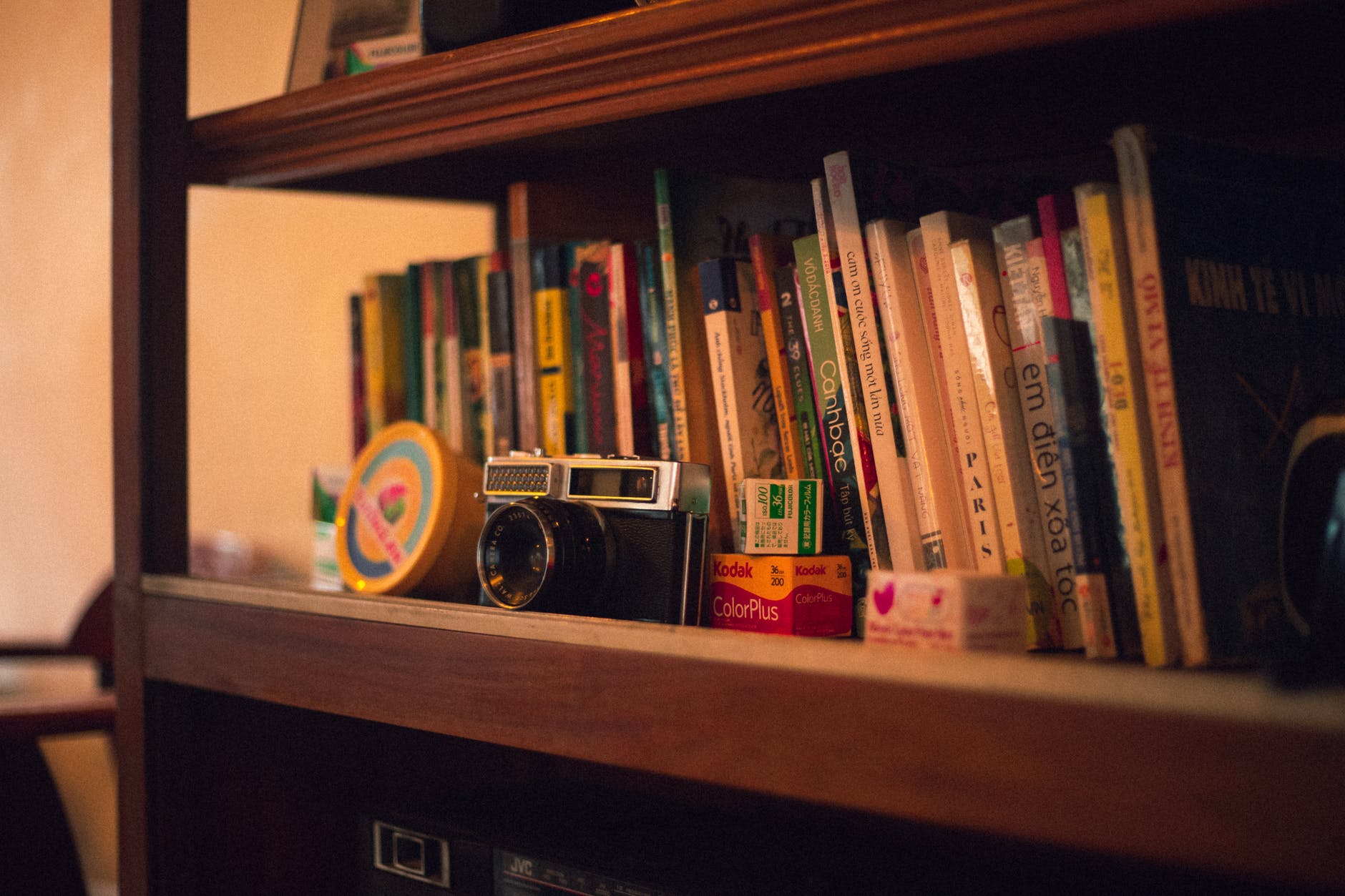 black vintage camera on bookshelf