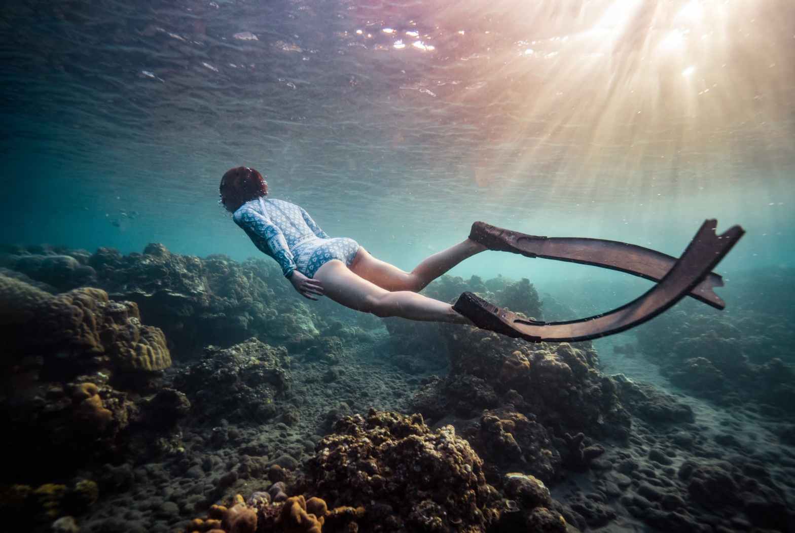 person freediving underwater