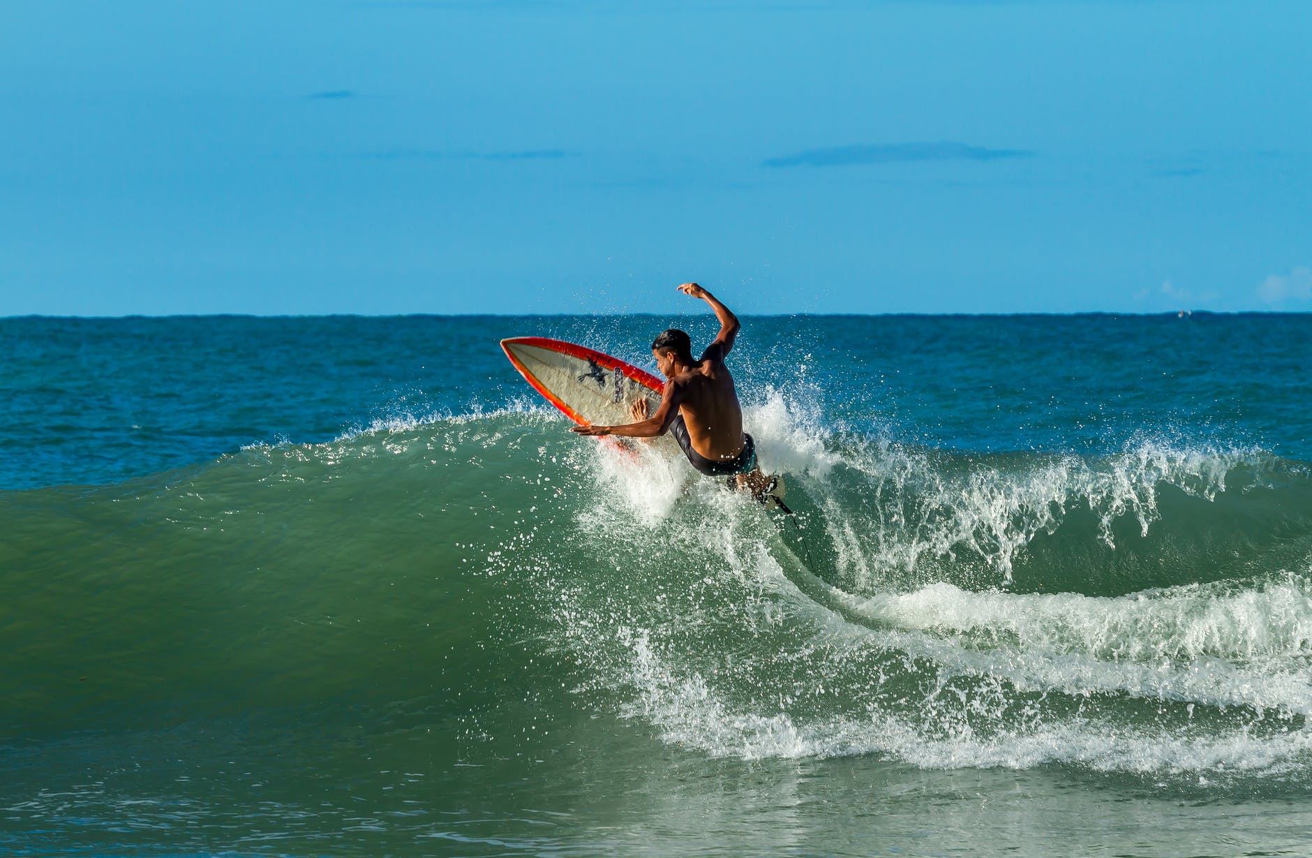 man surfing on big waves nz