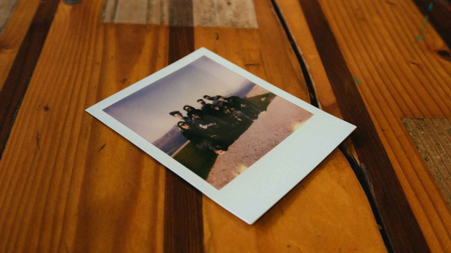 instant photo on brown wooden table