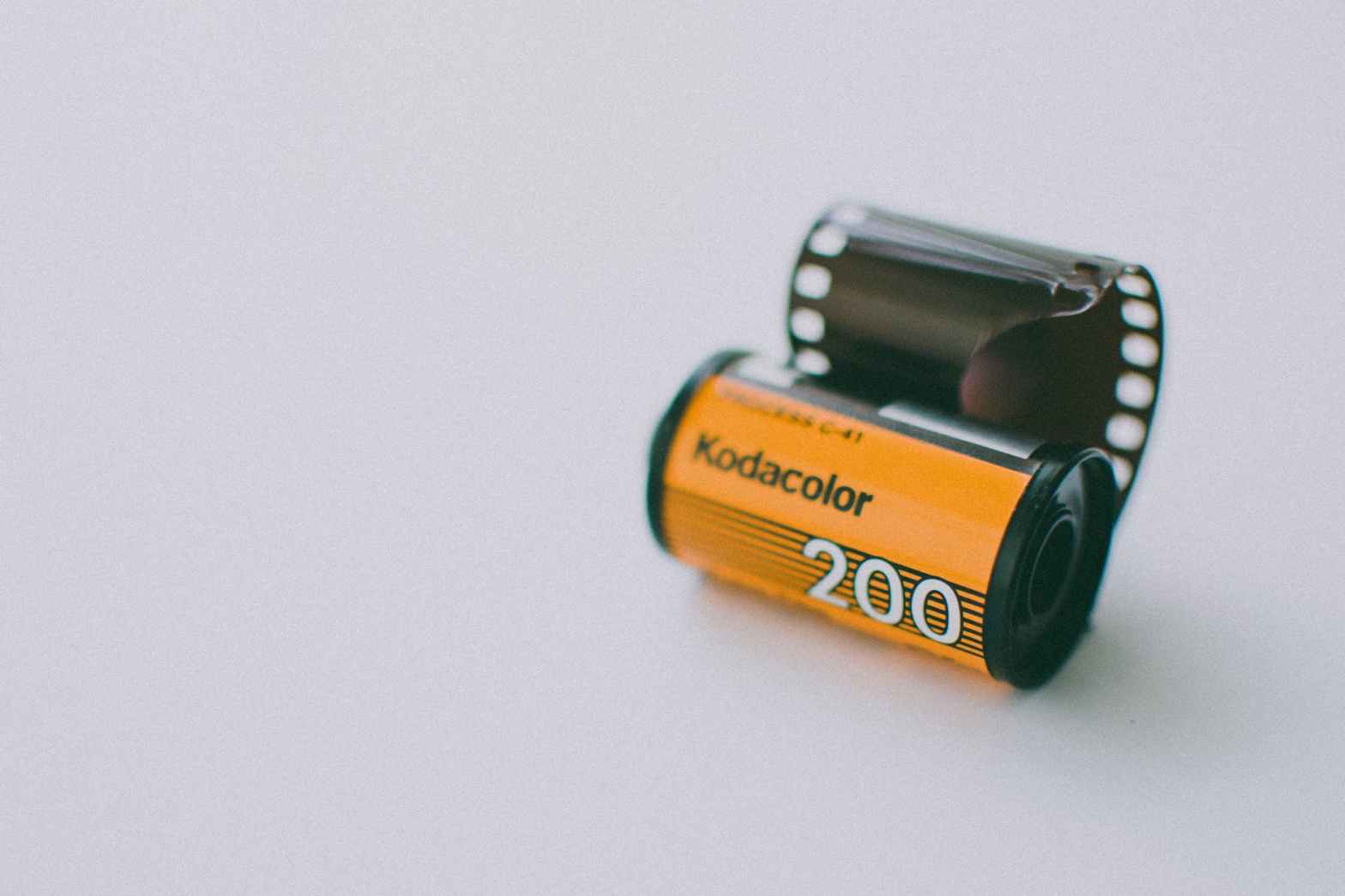 roll of kodak gold analogue camera film on a light blue background