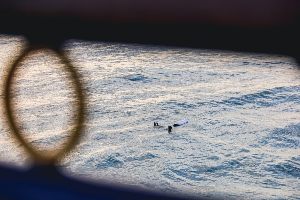 surfer in water at new brighton pier