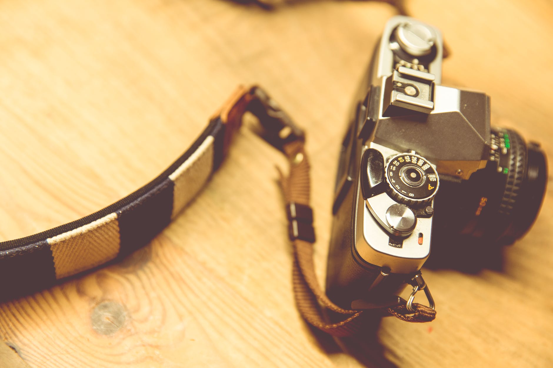 black and silver camera on brown wooden table