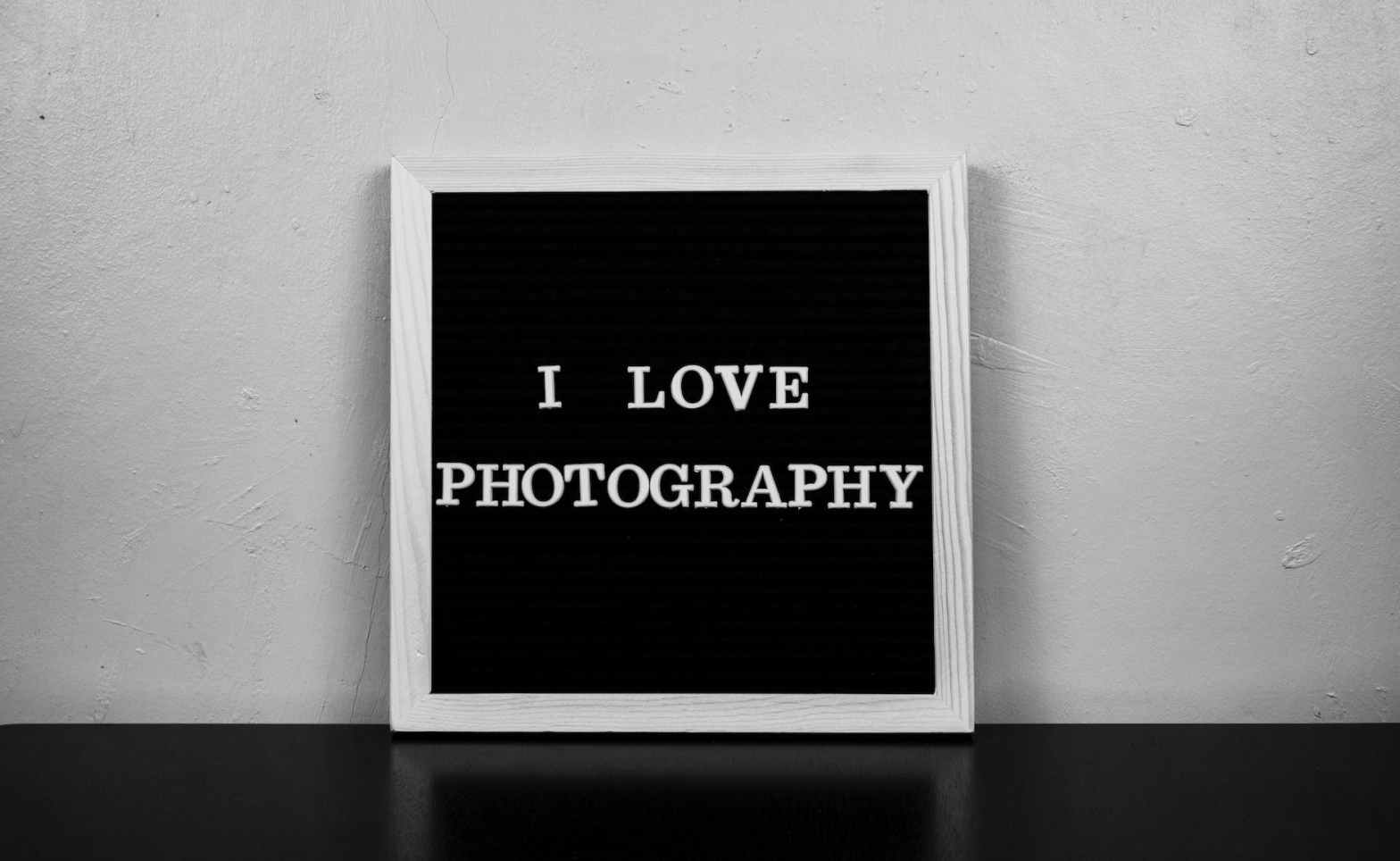 a board with writing saying i love photography